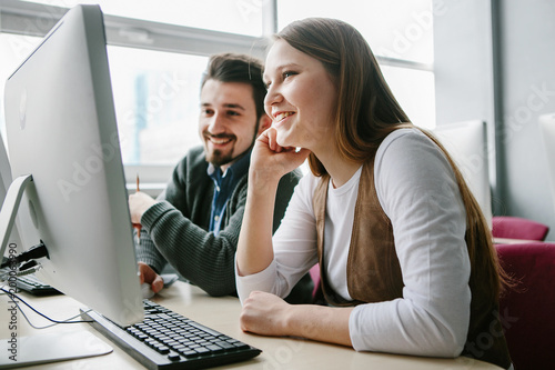 Young beautifull woman and man study together ,work with laptop and discuss queshions,start up project.