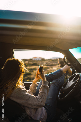 Wallpaper Mural Woman with smartphone in car in nature Torontodigital.ca