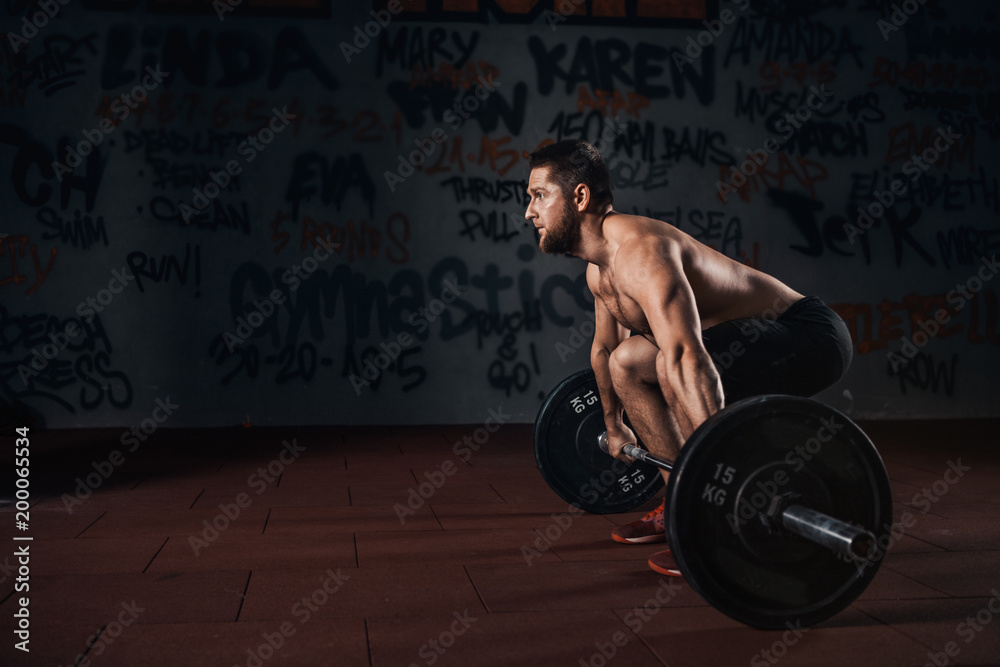 Muscular men lifting deadlift