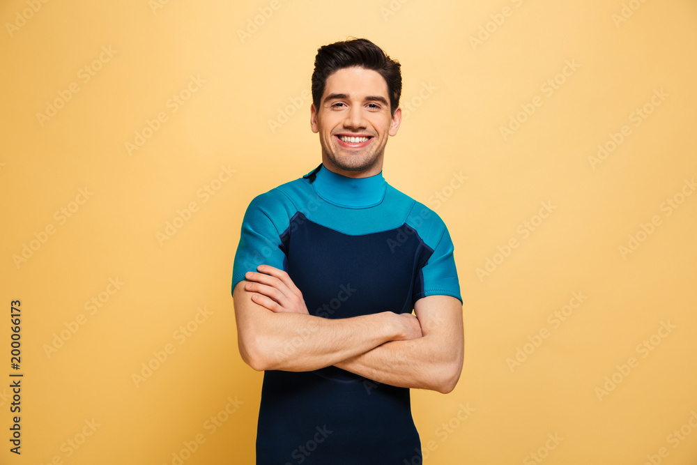 Joyful young man dressed in swimsuit