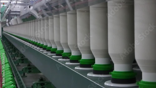 Machinery and equipment in the workshop for the production of thread. interior of industrial textile factory. the camera is stationary