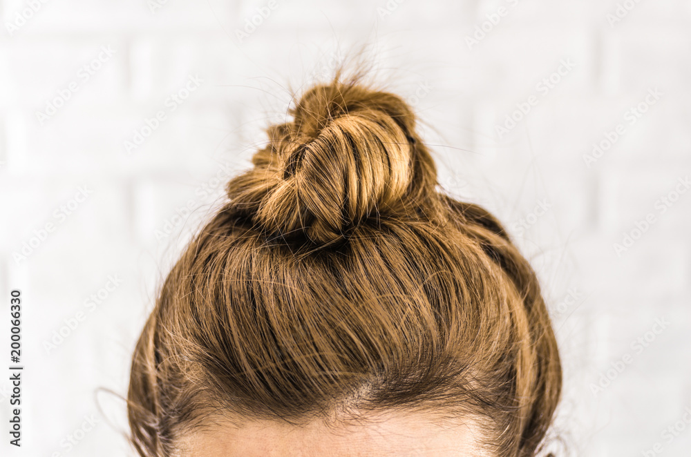 Head of a young woman. Hair bun front view Stock Photo | Adobe Stock