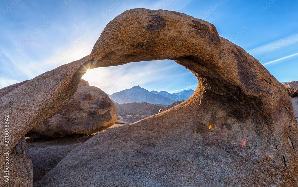 Mobius Arch on sunset with Whitney mountain on background. Alabama Hills, Eastern Sierra Nevada Mountains, Lone Pine, California, USA. Mobius Arch on sunset with Whitney mountain on background. Alabama Hills, Eastern Sierra Nevada Mountains, Lone Pine, California, USA.