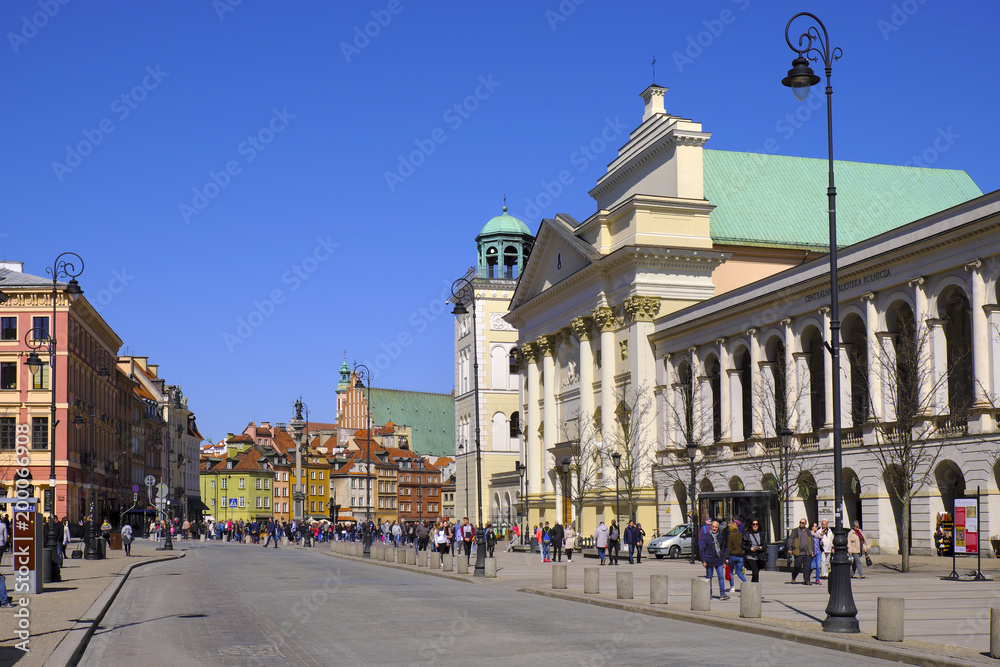 Warsaw, Poland - Historic quarter of Warsaw old town - St. Anne Church at Krakowskie Przedmiescie street with Royal Castle Square in background