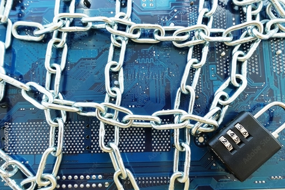 Computer mainboard with chain and padlock, information technology security concept
