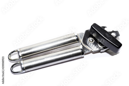 Chrome metal can opener on a white background © Peter