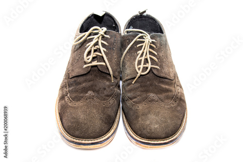Pair of brown suedem mens brogues on a white background