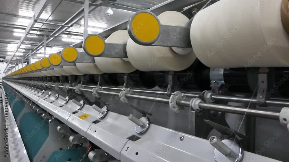 Machinery and equipment in the workshop for the production of thread. interior of industrial textile factory. the camera is stationary Machinery and equipment in the workshop for the production of thread. interior of industrial textile factory. the camera is stationary