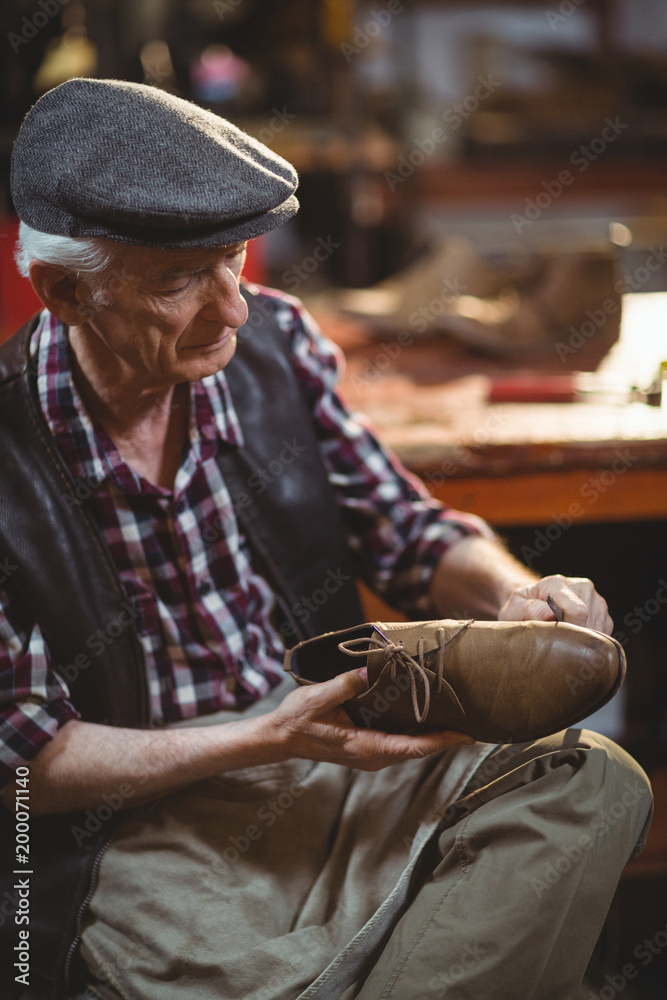 Shoemaker repairing a shoe Shoemaker repairing a shoe