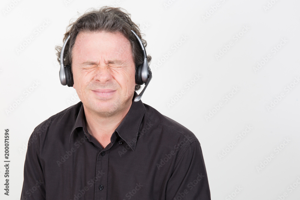 Stressed businessman pull a face Desperate sad employee tired at his desk in call center Crazy frustrated male Stressed businessman pull a face Desperate sad employee tired at his desk in call center Crazy frustrated male