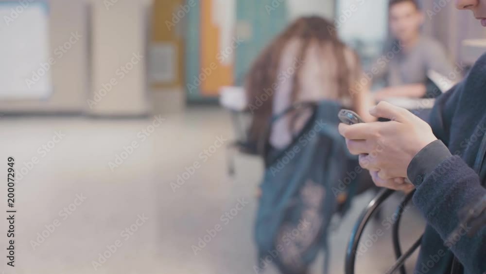 student playing on cellphone at university