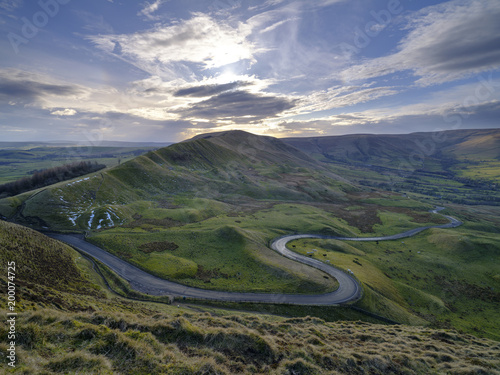 Spring Evening Sunset on Mam Tor with interesting sky looking towards RushUp Ridge with a view over the winding road from Winnats Pass to Edale