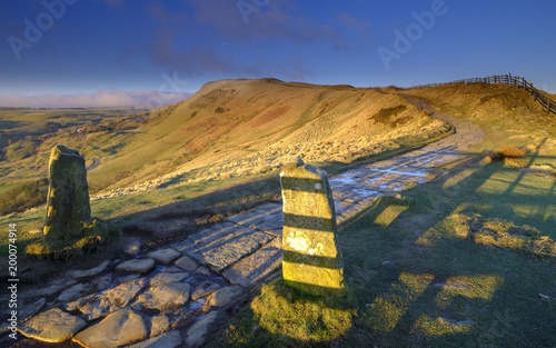 Spring Sunrise on Mam Tor overlooking Edale and the Hope Valley after a clear night with a light dusting of snow photo