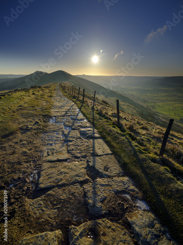 Spring Sunrise on Mam Tor overlooking Edale and the Hope Valley after a clear night with a light dusting of snow