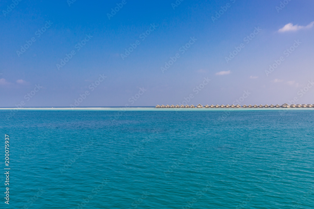 Luxury water villas and infinity blue sea. Summer luxurious travel destination