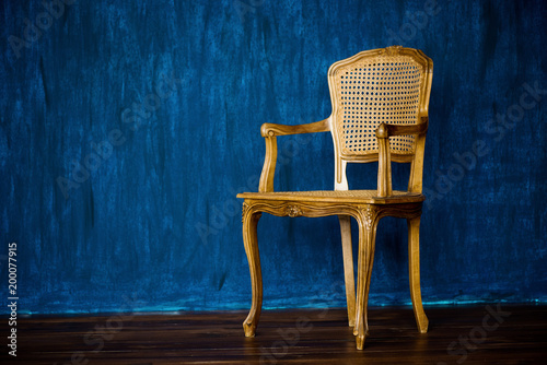 old chair on a blue wall background. photo