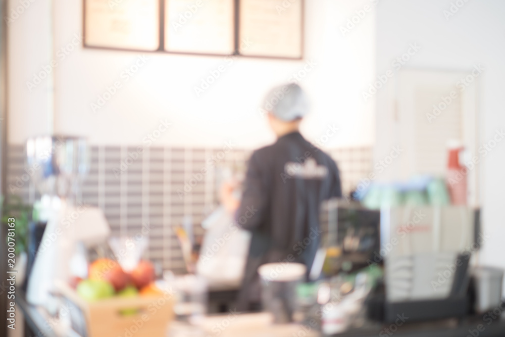 Abstract blur image of Barista preparing a coffee at the bar with bokeh for background usage. (vintage tone) Abstract blur image of Barista preparing a coffee at the bar with bokeh for background usage. (vintage tone)