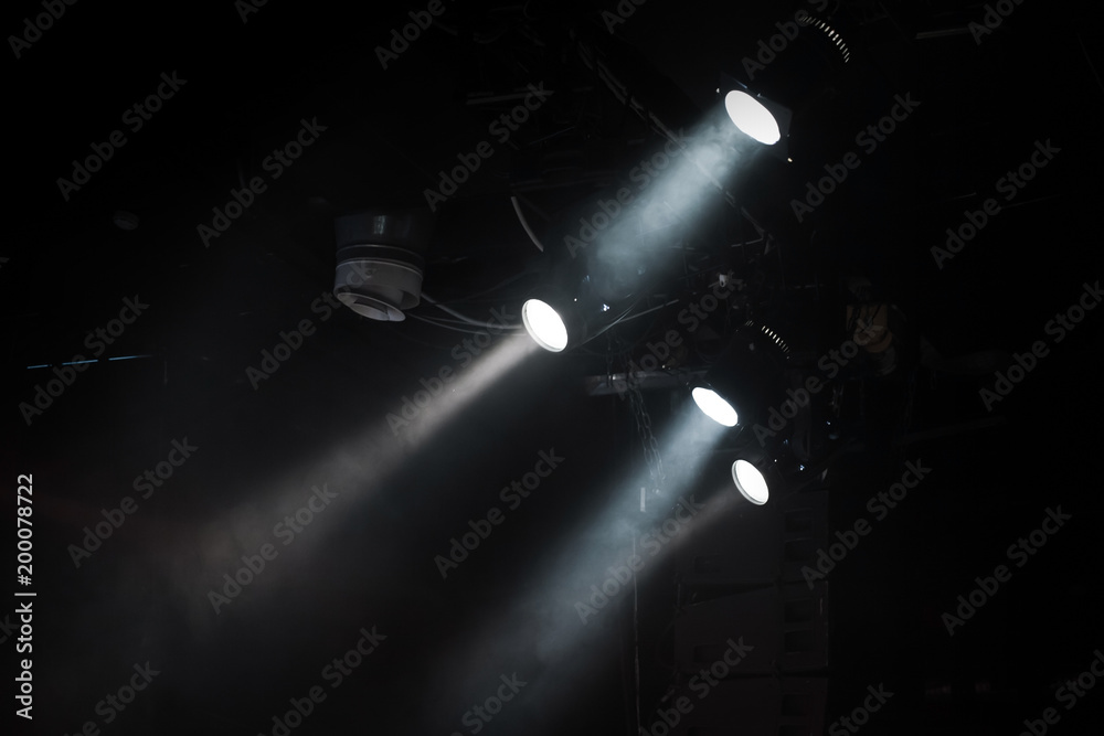 Group of spot lights with strong beams in smoke