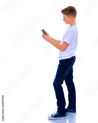 A little boy uses a mobile phone.