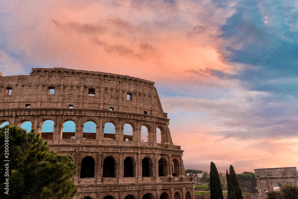 Colorful sunset sky over the Coliseum in Rome, Italy.