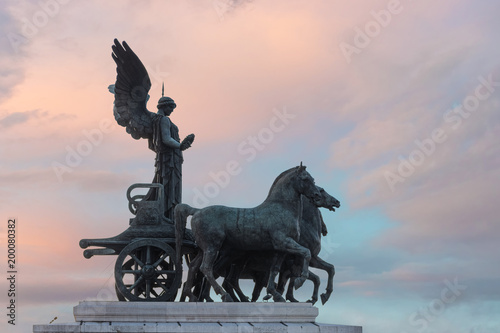 The antique sculpture Vittoriano against the sunset sky in Rome, Italy. © Paopano
