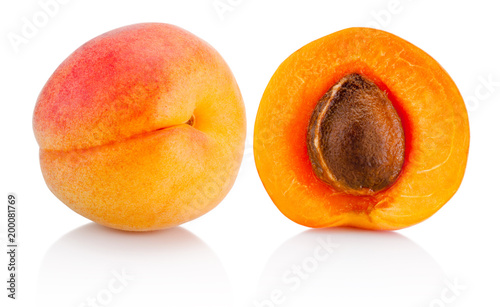 Fresh whole apricot fruit and half isolated on white background