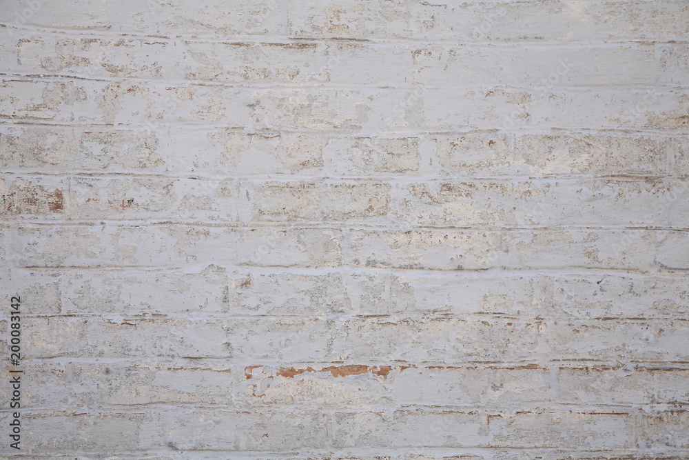 Old scratched white brick wall. Texture. Old scratched white brick wall. Texture.