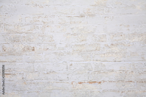 Old scratched white brick wall. Texture. 
