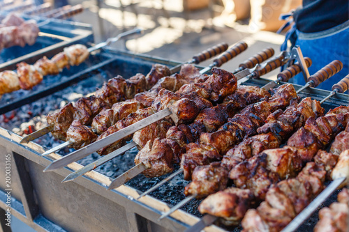 Marinated shashlik preparing on a barbecue grill over charcoal. Shashlik or Shish kebab popular in Eastern Europe and central asia. Shashlik. Roast Beef Kebabs On BBQ Grill.