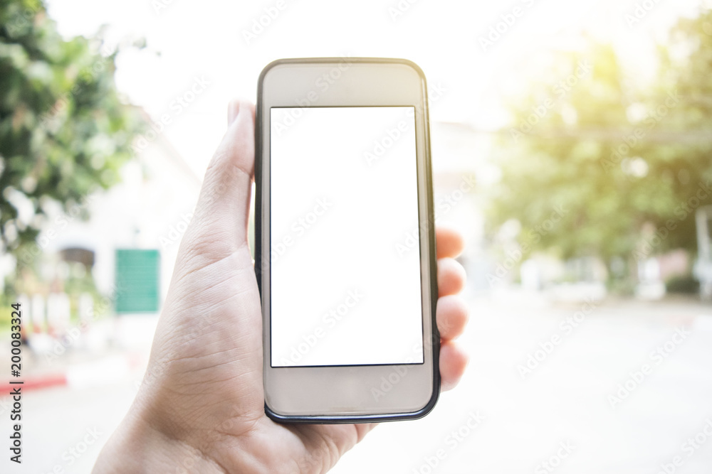 Young men use cell phones that leak the house at sunset. Young men use cell phones that leak the house at sunset.