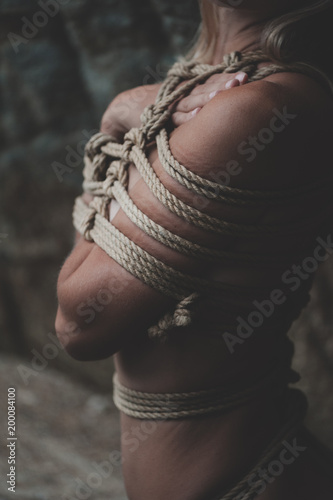 Woman bound with a rope in Japanese technique shibari photo