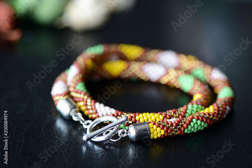 Ethnic style beaded necklace on a dark background close up