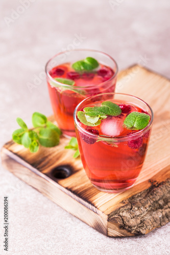 Aperitif with campari, mint and raspberry. Iced lemonade