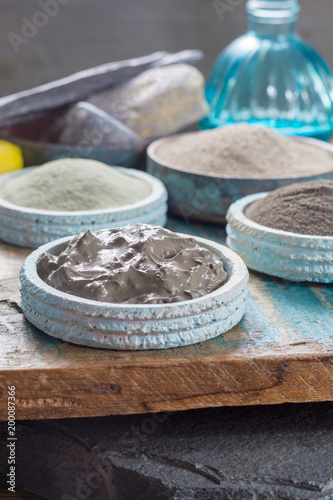Ancient nature minerals  different types of clay used for skincare  spa treatments  face masks  gray  black  green and blue mud  close up