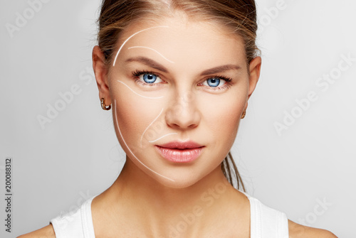 Portrait of young female with perfect smooth skin. Concept of cosmetology, facial massage and lifting effect.