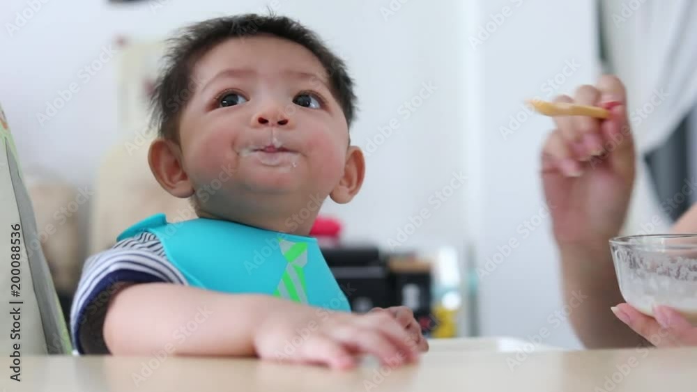 cute baby boy happy eating time with mother feeding puree tasty cute baby boy happy eating time with mother feeding puree tasty