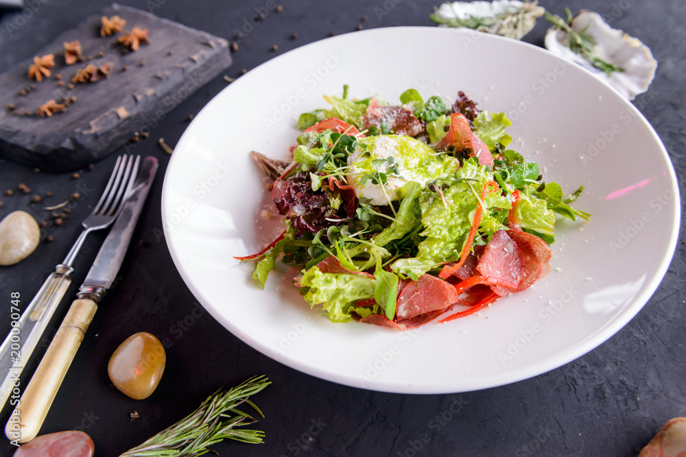 fresh salad in beautiful composition on a concrete background fresh salad in beautiful composition on a concrete background