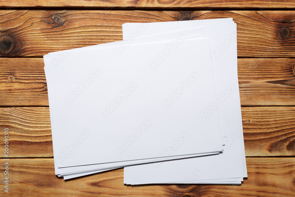 White business card on wooden table. Blank portrait A4. White business card on wooden table. Blank portrait A4.