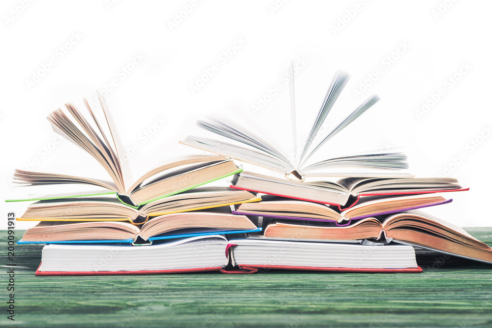 Open books stacked on wooden table Open books stacked on wooden table