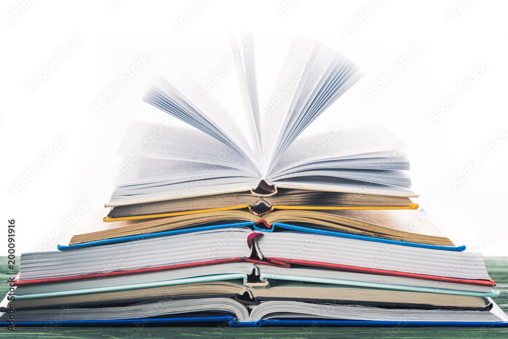 Stack of open books on wooden table Stack of open books on wooden table