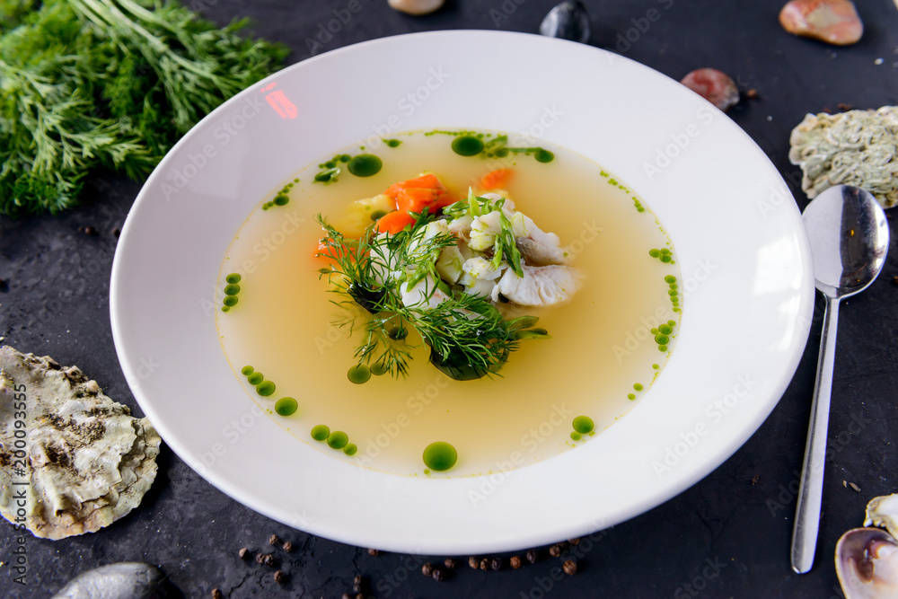seafood soup in a white plate on a concrete background seafood soup in a white plate on a concrete background