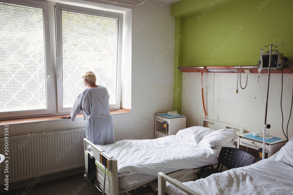 Senior woman standing near window Senior woman standing near window