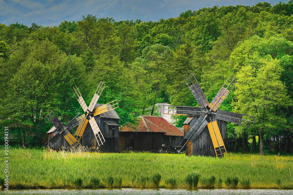 Naklejka premium Windmills on the Bank of Lake