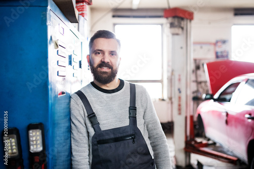 Portrait of a man mechanic in a garage.