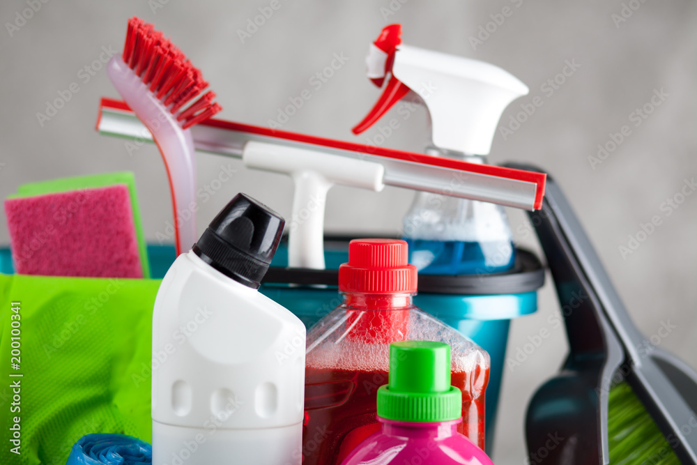 Cleaning supplies on grey background Cleaning supplies on grey background