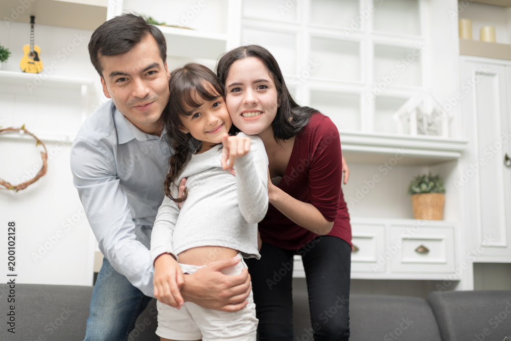 Fototapeta premium Happy Family spending time together at home. In selective focus of funny ride on back and run around.
