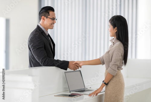 Happy Businessman in Hotel check in at reception or front office being given key card. Classy welcome Concept.