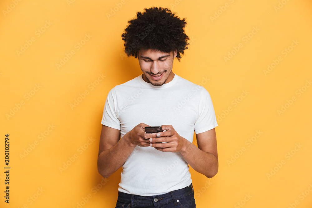 Portrait of a happy young african guy using mobile phone Portrait of a happy young african guy using mobile phone