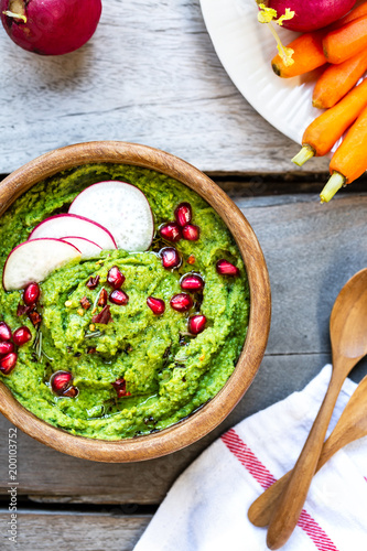 Spinach Hummus with Pomegranate topping by fresh Baby carrots and Radish