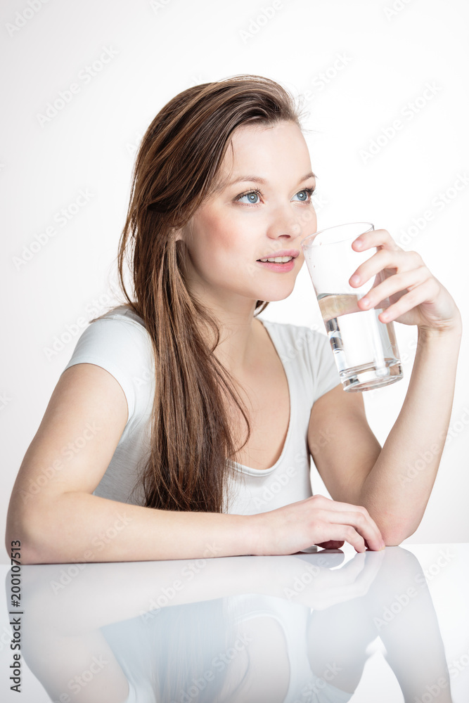 Closeup portrait of a young attractive woman drinking water from glass. Closeup portrait of a young attractive woman drinking water from glass.